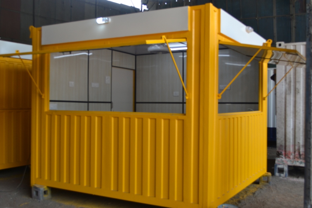 Yellow portable shop cabin with lift-up counter windows